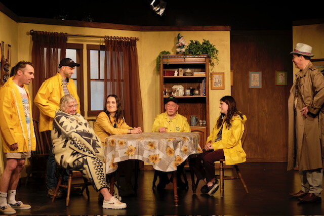A full cast performing a scene in costume on the Shuswap Theatre stage.